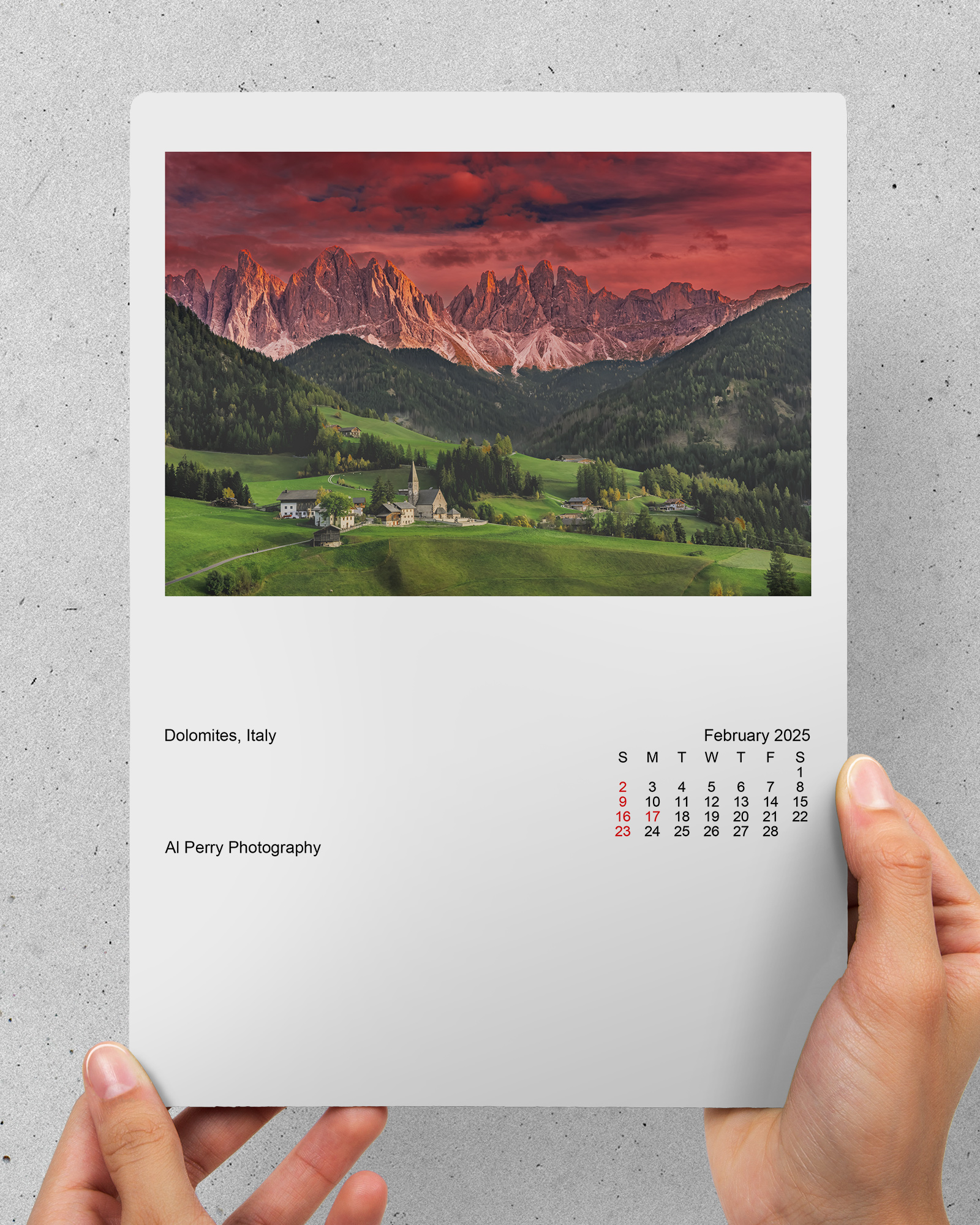 Hands holding Dolomite Italy calendar print.