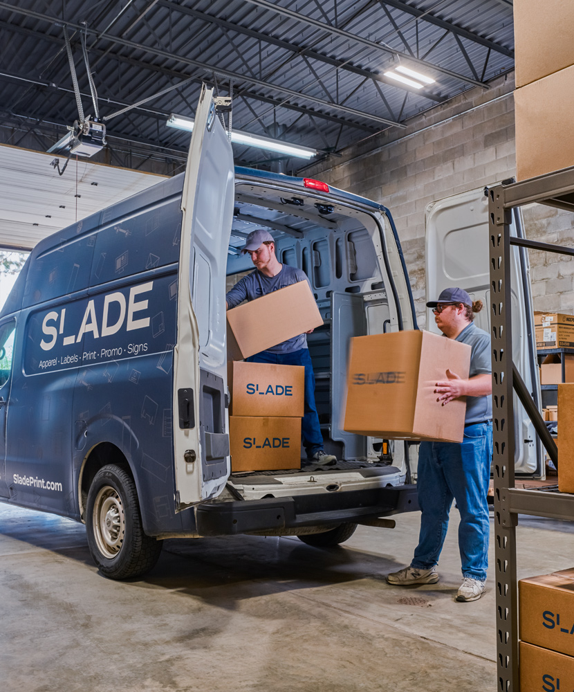 Loading boxe into SLADE delivery van.