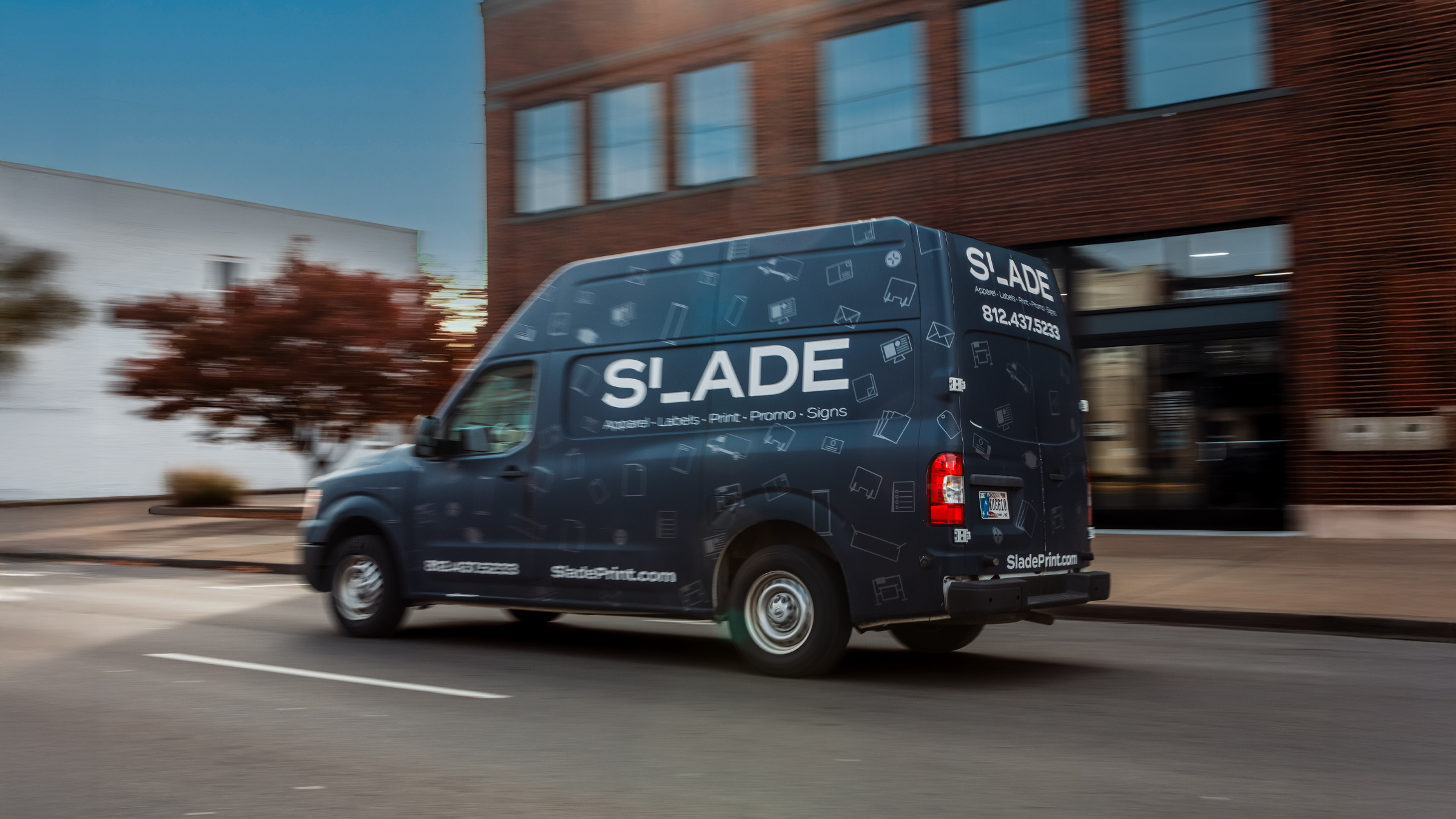 SLADE delivery van in motion on road.