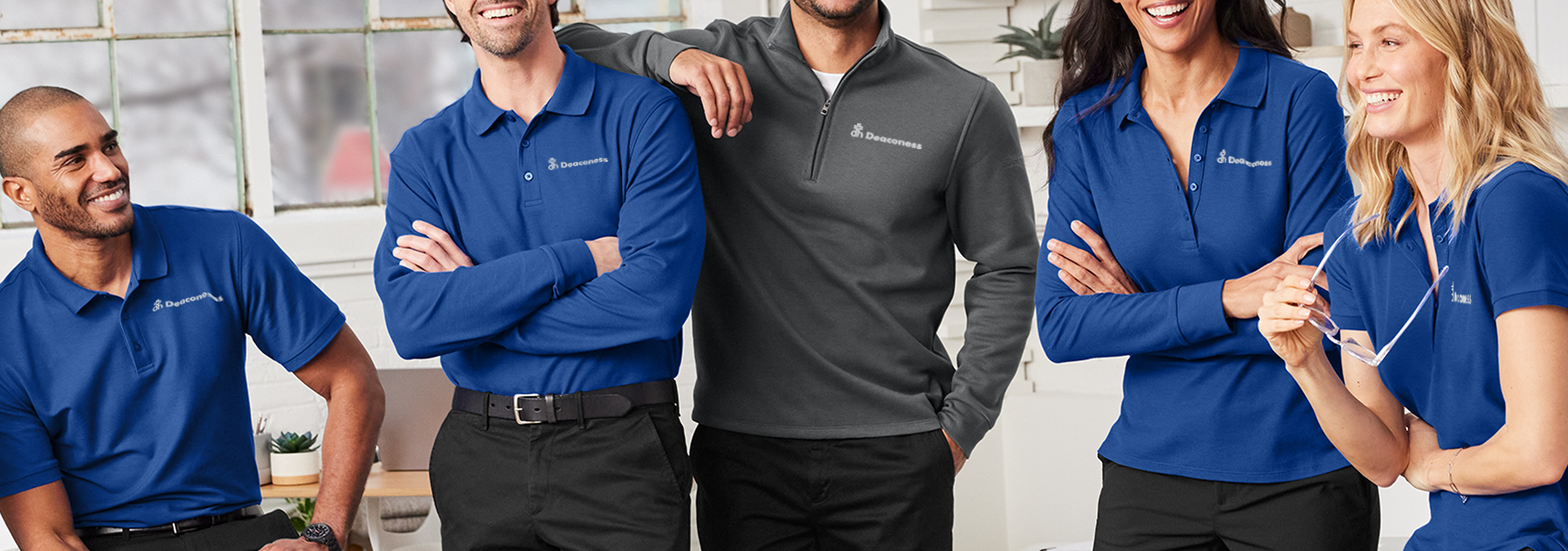 Group of Deaconess employees in branded shirts.