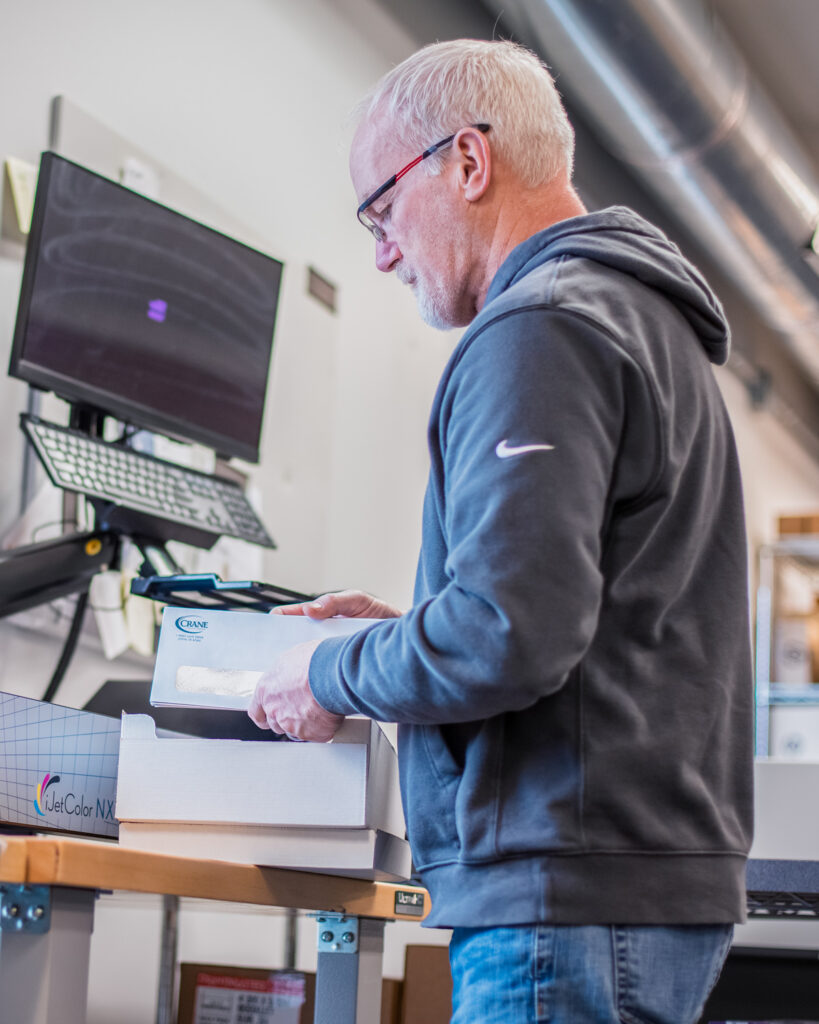 SLADE employee sorting direct mail.