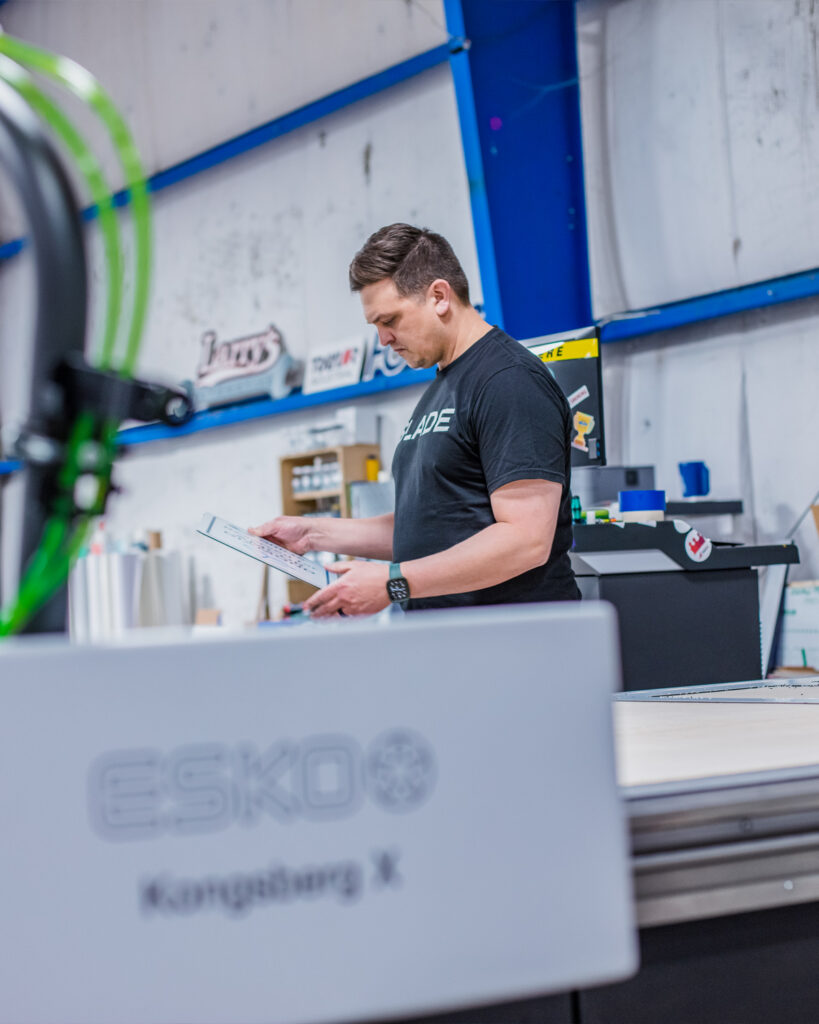 SALDE employee preparing sign router.
