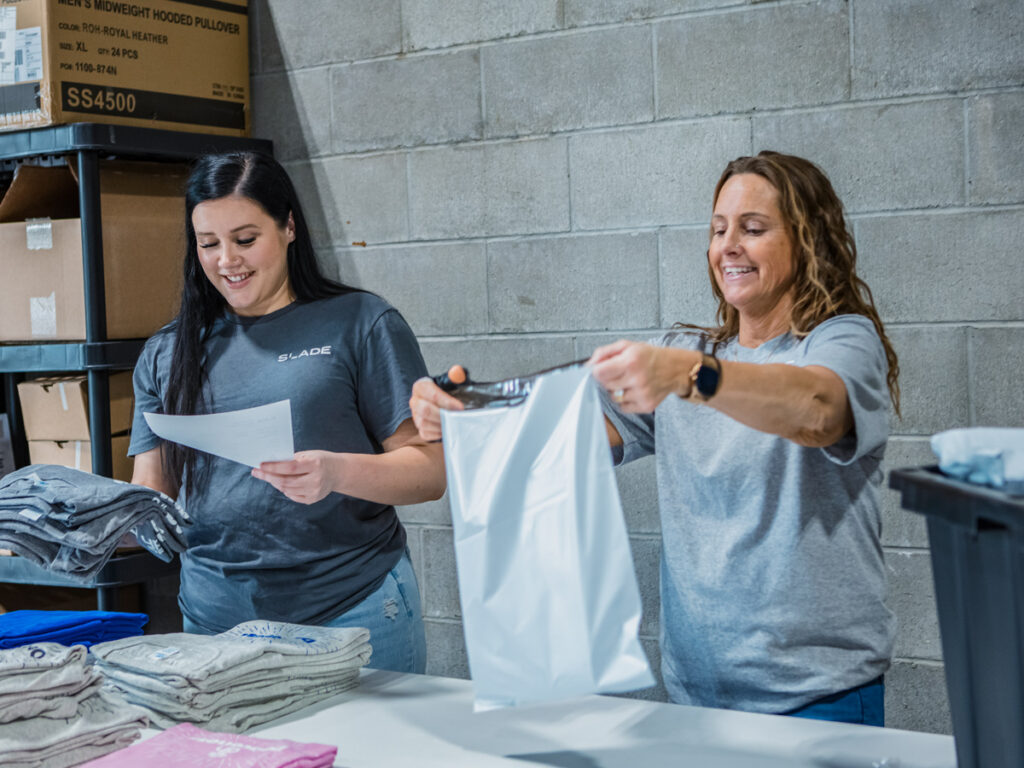 SLADE employees packing apparel orders.