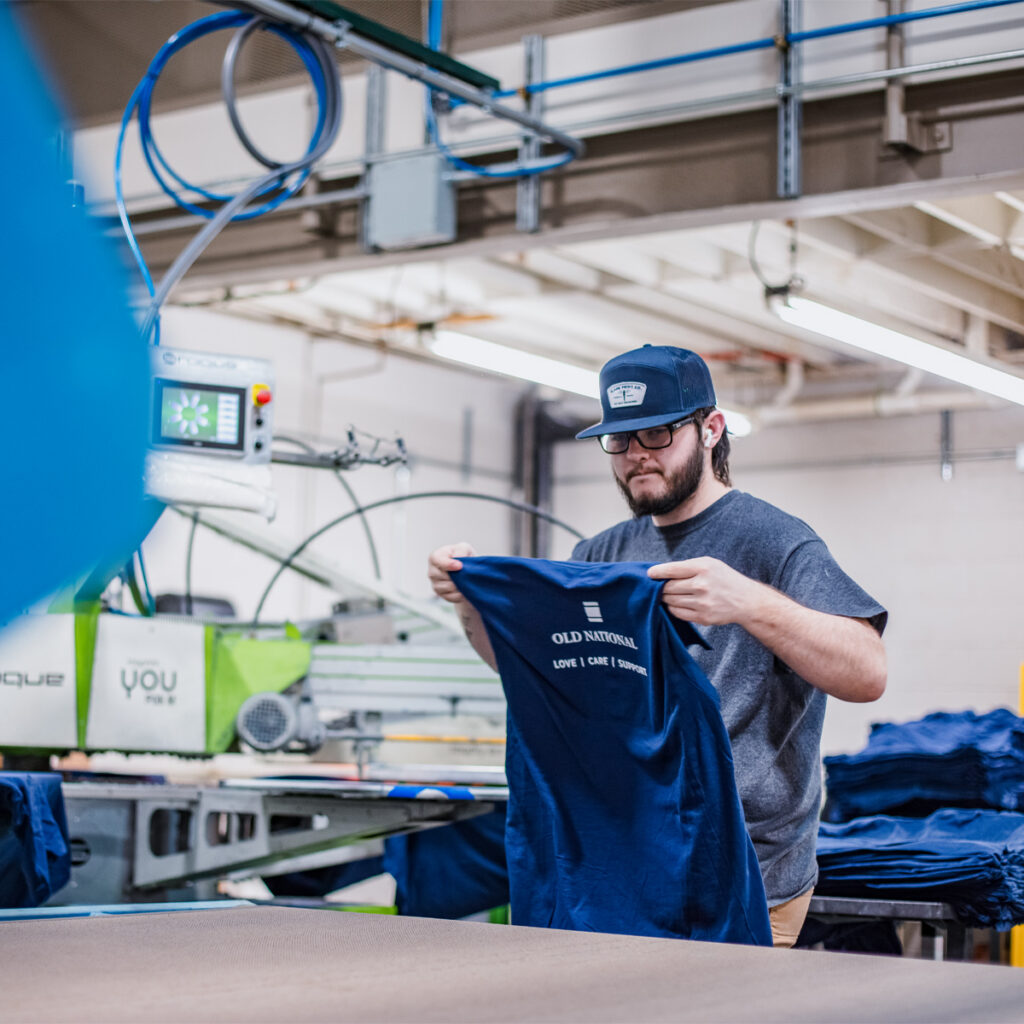 SLADE employee operating screen print dryer.