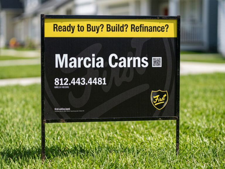 Yard sign advertising Marcia Carns at First Financial Bank for buying, building or refinancing a home.