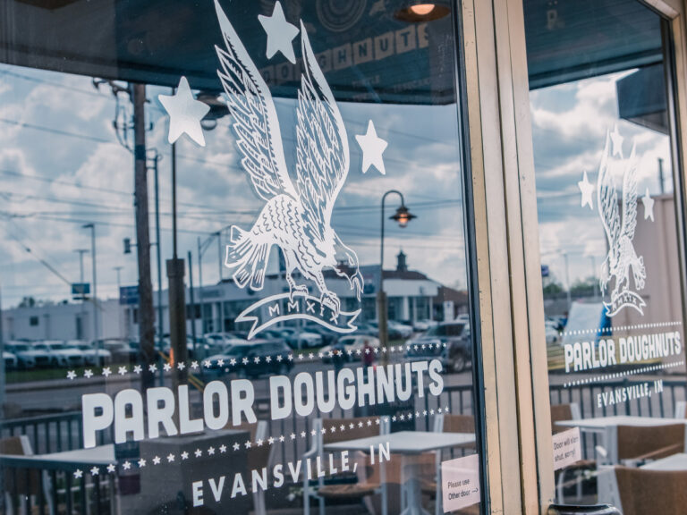White Parlor Doughnuts lettering and eagle graphics on storefront windows.