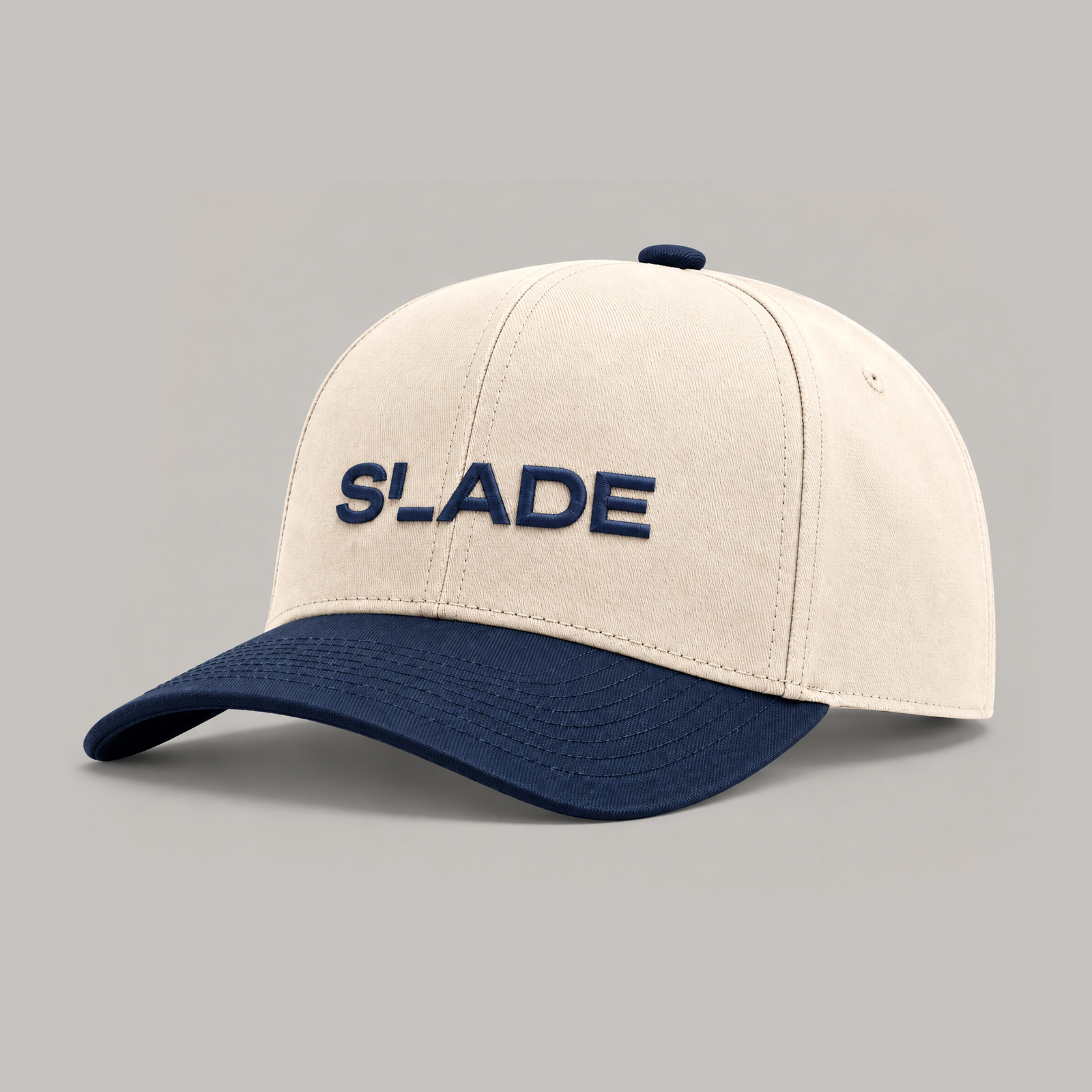 Cream cap with a navy brim and Slade embroidered across the front.