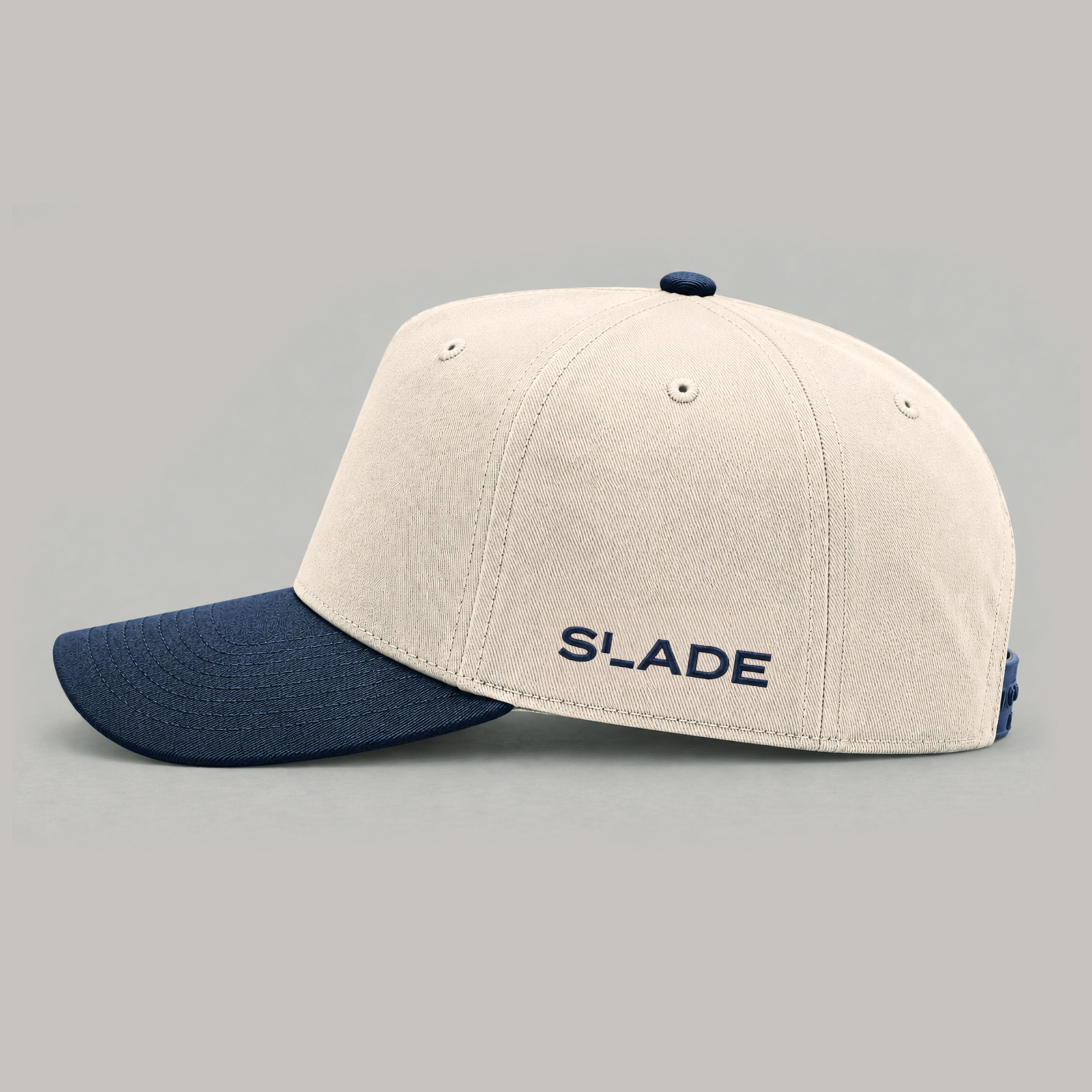 Cream cap with a navy brim and Slade lettering on the side panel.