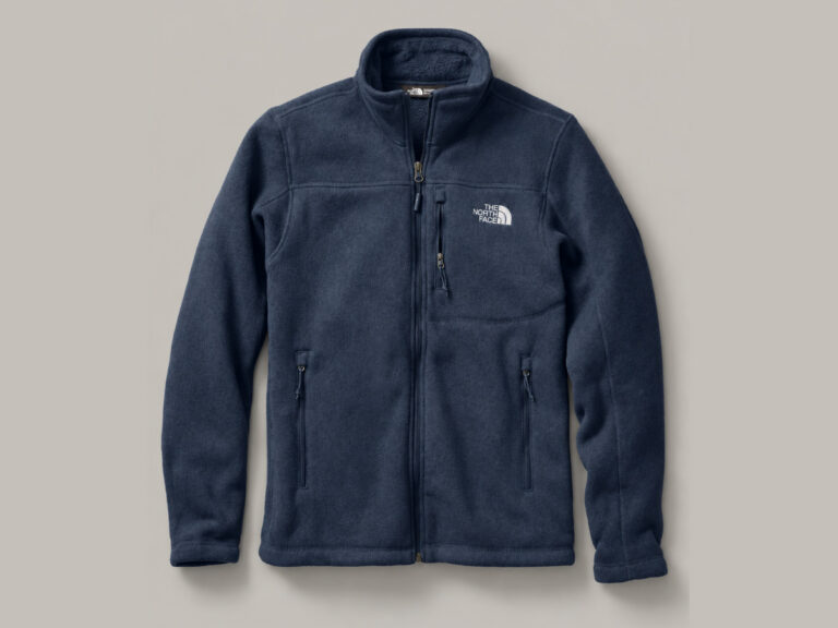 Navy fleece jacket with a full front zipper, zippered pockets and a small chest logo.