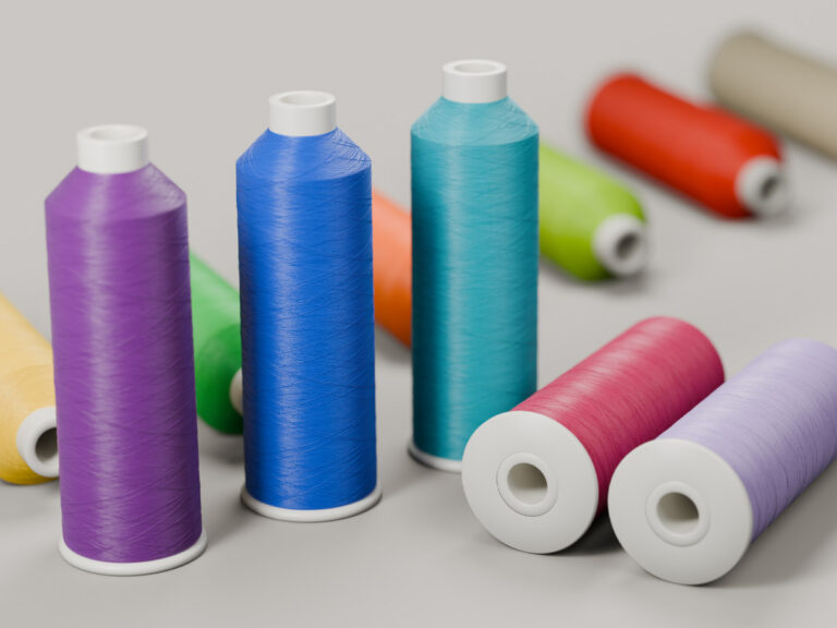 Spools of embroidery thread in purple, blue, turquoise and other colors.