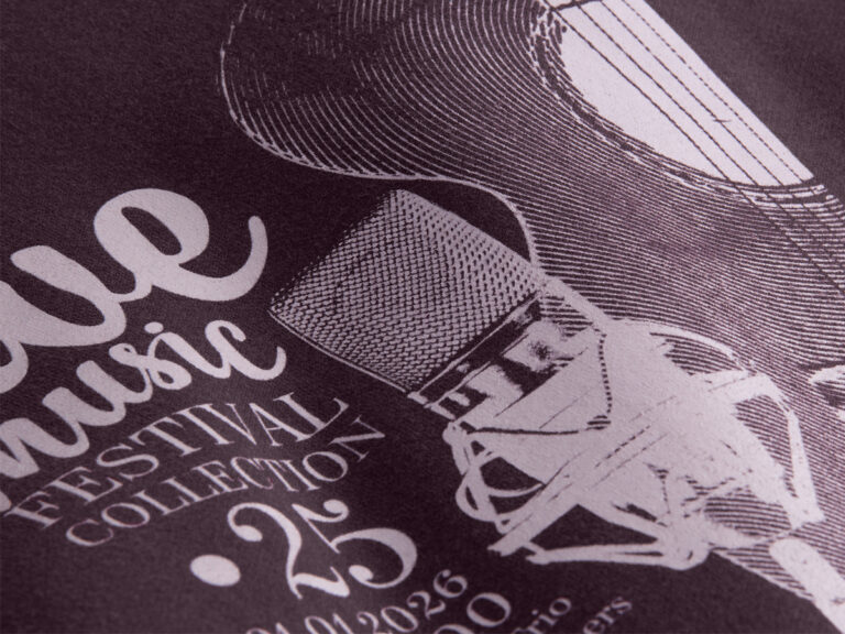 Pale lettering and a detailed microphone graphic printed on dark fabric.