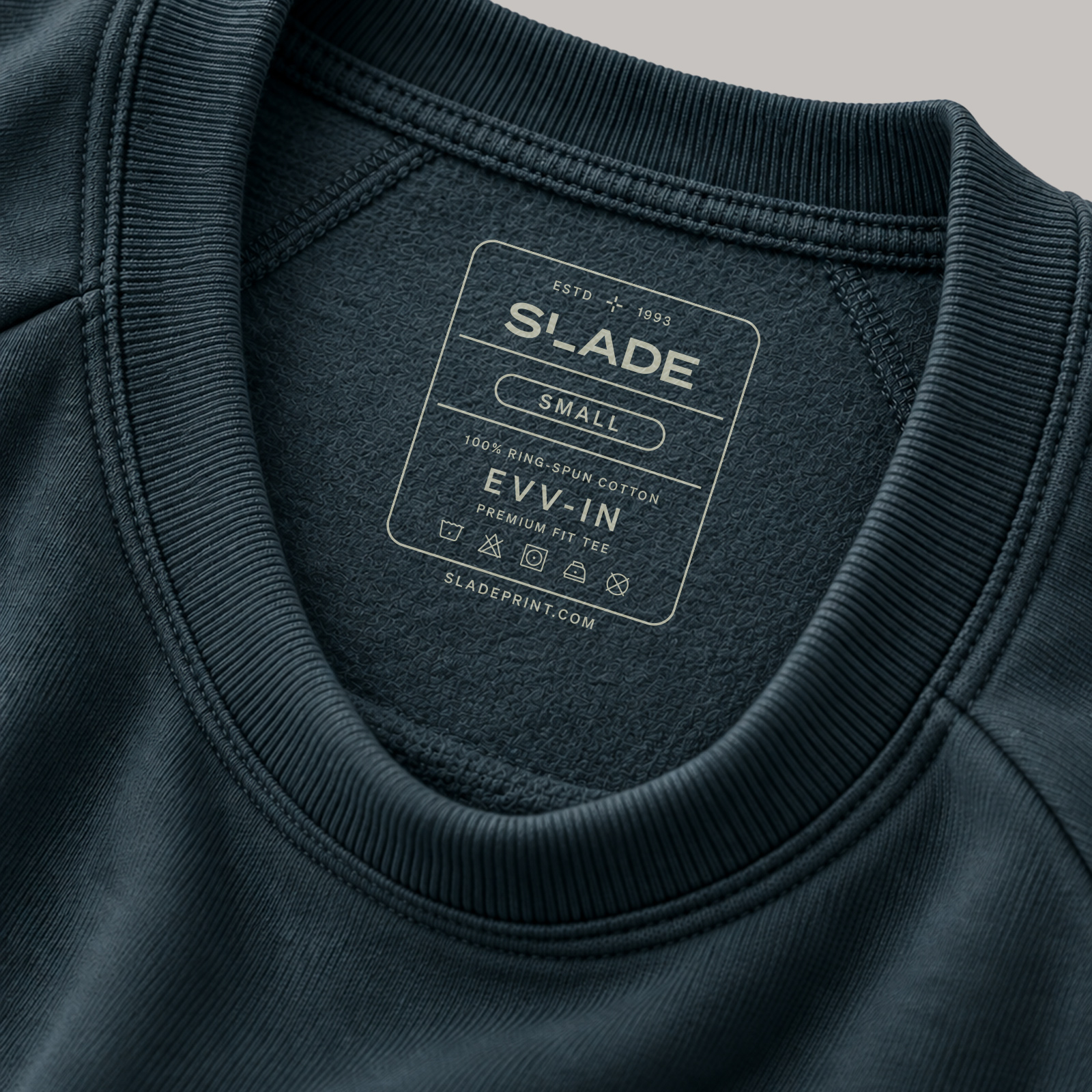 Slade branding and care symbols printed inside a dark sweatshirt's back neckline.
