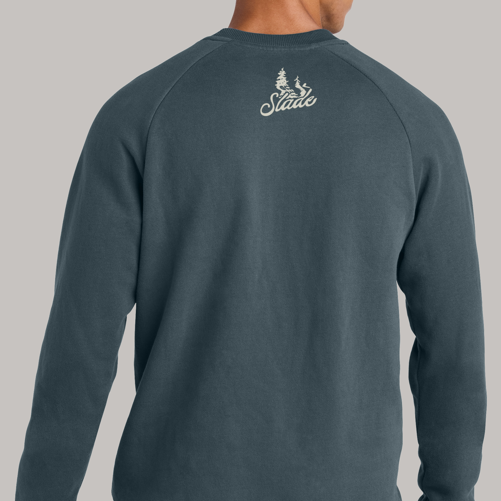 Back of a dark sweatshirt with a small Slade graphic printed just below the neckline.