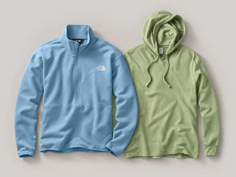 Light blue quarter-zip fleece beside a light green hooded pullover.