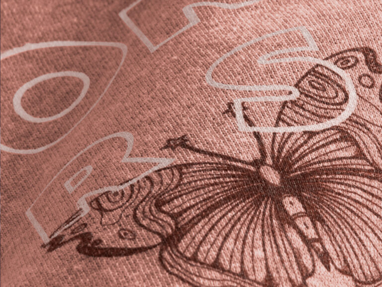 Butterfly line art and pale outlined lettering printed on pink fabric.