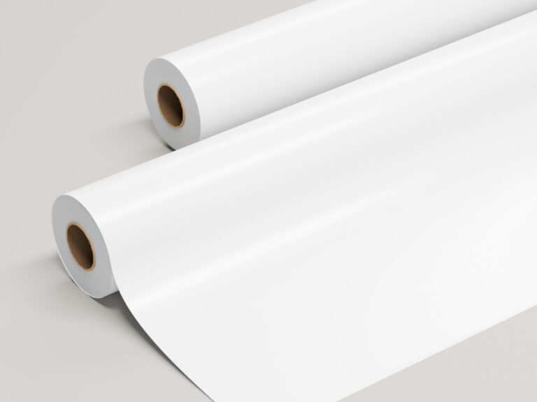 Two rolls of glossy white sign material, with one partly unrolled.