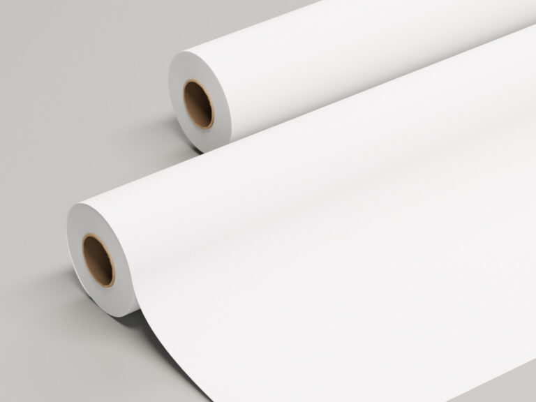 Two rolls of matte white sign material, with one partly unrolled.