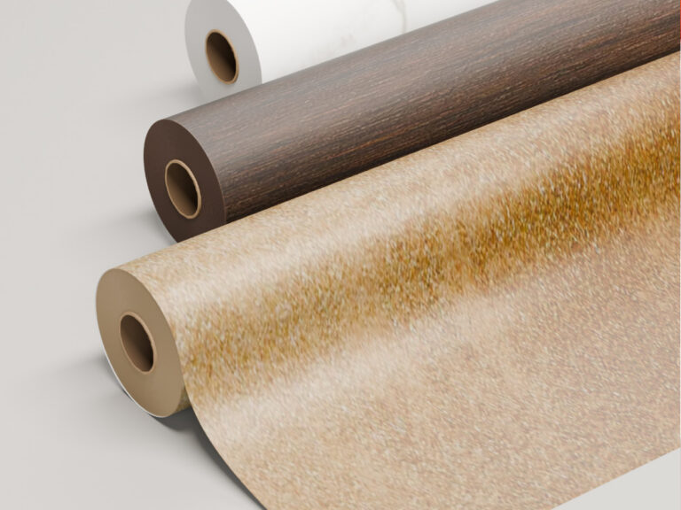 Rolls of white, wood-grain and gold-textured surface film.