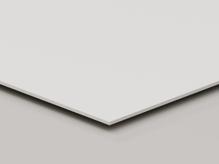 White sign board shown at an angle to reveal its thick core.