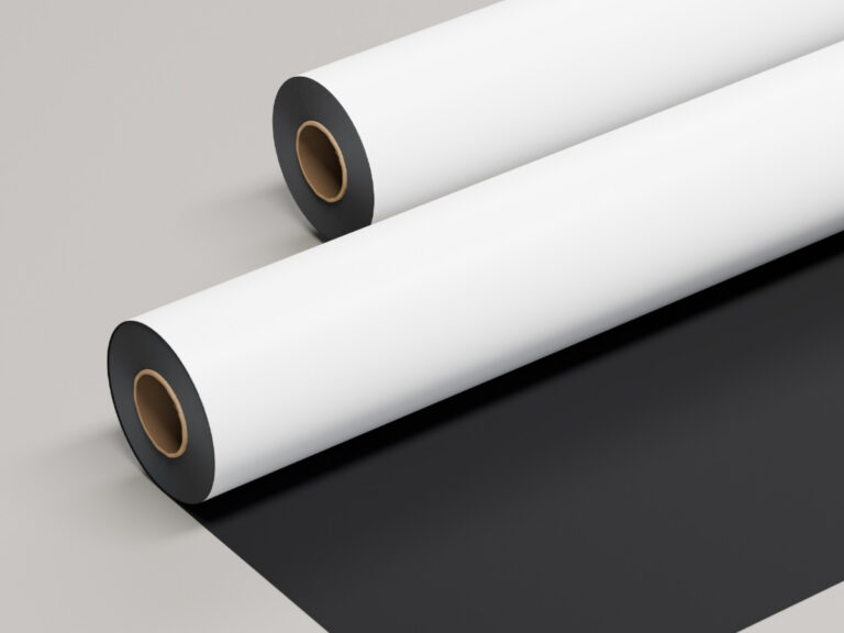 White sign material rolled back to reveal a black underside.
