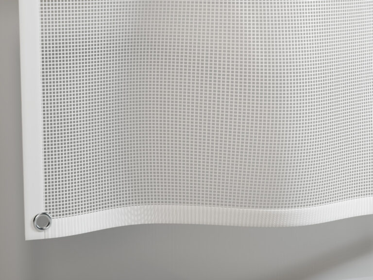 White mesh banner corner with a reinforced edge and metal grommet.