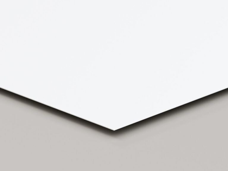 Thin white sign sheet shown at an angle to reveal its corner and edge.